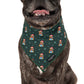 dog wearing dog bandana with teddy bears in santa hats